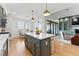 Open concept kitchen with a large island, modern appliances, a breakfast nook and sliding doors at 16671 Red Cliff Cir, Morrison, CO 80465
