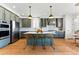 Bright kitchen featuring an island with bar seating, stainless appliances, and hardwood flooring at 16671 Red Cliff Cir, Morrison, CO 80465