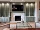 Elegant living room with custom built-ins, a cozy fireplace, and stylish decor on a soft, plush rug at 16671 Red Cliff Cir, Morrison, CO 80465
