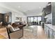 Bright living area featuring hardwood floors, stylish furniture, built-in cabinets and sliding doors to the patio at 16671 Red Cliff Cir, Morrison, CO 80465
