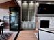 Bright living area with custom shelving, a modern fireplace, and easy access to the outdoor deck and dining space at 16671 Red Cliff Cir, Morrison, CO 80465