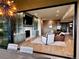 Spacious living room featuring a stone accent wall, fireplace, and seamless transition to the outdoor dining area at 16671 Red Cliff Cir, Morrison, CO 80465