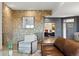 Elegant living room featuring a stone accent wall, hardwood floors, and modern furniture at 16671 Red Cliff Cir, Morrison, CO 80465