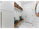 Well organized mudroom featuring cubbies, coat hooks, bench seating, and white shiplap walls at 16671 Red Cliff Cir, Morrison, CO 80465