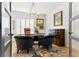 Bright office space with dark furniture, light hardwood floors and a modern chandelier at 16671 Red Cliff Cir, Morrison, CO 80465