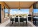 Beautiful outdoor patio boasts stunning mountain views, dining table, and stainless steel grill at 16671 Red Cliff Cir, Morrison, CO 80465