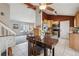 Open-concept kitchen with stainless steel appliances and an adjacent dining area at 11125 W Alamo Pl, Littleton, CO 80127