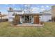 Backyard patio with outdoor seating and pergola in a grassy yard at 11125 W Alamo Pl, Littleton, CO 80127