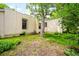 Backyard featuring mature tree, grass, and neutral exterior of the property at 130 S Humboldt St, Denver, CO 80209