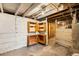 Unfinished basement with wooden shelves and concrete floor, perfect for storage at 130 S Humboldt St, Denver, CO 80209