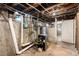 Basement with exposed pipes and water heater, showing the home's infrastructure at 130 S Humboldt St, Denver, CO 80209