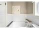 Classic bathroom with a soaking tub and tiled walls at 130 S Humboldt St, Denver, CO 80209