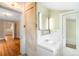 Clean bathroom with a white vanity, tiled walls, and a doorway leading to other rooms at 130 S Humboldt St, Denver, CO 80209