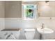 Well-lit bathroom with tile accents, a window, and modern fixtures including a bidet at 130 S Humboldt St, Denver, CO 80209