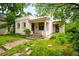 Charming single-story home featuring a stucco exterior, decorative windows, and a tile roof at 130 S Humboldt St, Denver, CO 80209