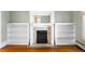 Close up of decorative fireplace with built-in shelving in the living room at 130 S Humboldt St, Denver, CO 80209