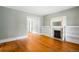 Bright living room boasts hardwood floors, decorative fireplace with built-in shelving at 130 S Humboldt St, Denver, CO 80209