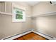 Functional walk-in closet space with a window and installed shelving for optimal organization at 130 S Humboldt St, Denver, CO 80209