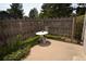 Small patio area with a white table and wooden fence at 522 W Crestline Cir # 8A3, Littleton, CO 80120