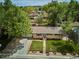 Aerial view of a charming home with mature trees, well-manicured lawn, and inviting curb appeal at 6410 Independence Way, Arvada, CO 80004