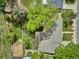 An aerial view highlights the landscaped yard and mature trees, enhancing the property's curb appeal and privacy at 6410 Independence Way, Arvada, CO 80004