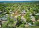 An aerial view shows a charming neighborhood with tree-lined streets and well-maintained homes nestled among lush greenery at 6410 Independence Way, Arvada, CO 80004