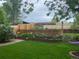 A landscaped yard with a garden and a swing offers a peaceful retreat and enhances the property's outdoor living space at 6410 Independence Way, Arvada, CO 80004