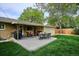 Outdoor living area with a patio dining set, grill, and a partially covered seating area at 6410 Independence Way, Arvada, CO 80004