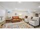 Finished basement with ample seating features a plush rug, leather sofas, and lots of space for relaxation and entertainment at 6410 Independence Way, Arvada, CO 80004