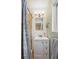 Bathroom features a white vanity with storage, a shower with patterned curtain, and neutral color scheme at 6410 Independence Way, Arvada, CO 80004
