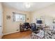Bright home office features hardwood floors, a window with pleasant views, and room for a desk and seating at 6410 Independence Way, Arvada, CO 80004