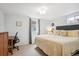 Comfortable bedroom featuring neutral decor, a cozy bed, and a functional workspace at 6410 Independence Way, Arvada, CO 80004
