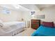 Cozy bedroom with two beds, featuring natural light and dresser storage at 6410 Independence Way, Arvada, CO 80004