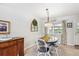 Sunlit dining room with neutral walls, stylish decor, and comfortable seating at 6410 Independence Way, Arvada, CO 80004