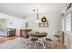 Bright dining room with stylish light fixture and view of living area at 6410 Independence Way, Arvada, CO 80004