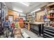 Well-lit garage featuring a workbench, tool storage, and additional storage space at 6410 Independence Way, Arvada, CO 80004