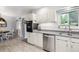 Updated kitchen with stainless steel appliances, sleek countertops, and tile backsplash at 6410 Independence Way, Arvada, CO 80004