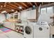 Functional laundry area with washer, dryer, cabinets, and countertop space at 6410 Independence Way, Arvada, CO 80004