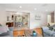 Open-concept living area with hardwood floors, a view to the dining room at 6410 Independence Way, Arvada, CO 80004