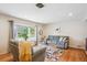 Comfortable living room with a bay window, hardwood floors, and neutral decor at 6410 Independence Way, Arvada, CO 80004