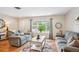 Inviting living room with hardwood floors, neutral paint, and comfortable seating at 6410 Independence Way, Arvada, CO 80004