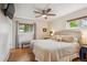 Inviting main bedroom features a large window, hardwood floors, and a cozy bench, creating a relaxing retreat at 6410 Independence Way, Arvada, CO 80004