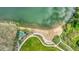 Aerial view of a sandy beach and park area along a lake, surrounded by green spaces at 7277 W Adriatic Cir, Lakewood, CO 80227