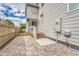 Private brick-paved backyard with a small deck, perfect for outdoor dining and relaxation at 7277 W Adriatic Cir, Lakewood, CO 80227