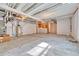 Unfinished basement featuring a concrete floor, water heater, and exposed ceiling beams at 7277 W Adriatic Cir, Lakewood, CO 80227