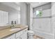 Bathroom with a bathtub, modern vanity, a large mirror, and neutral finishes at 7277 W Adriatic Cir, Lakewood, CO 80227