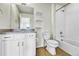 Neutral bathroom featuring white cabinets, granite countertop, shower-tub combo, and tile flooring at 7277 W Adriatic Cir, Lakewood, CO 80227