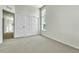 Bright and airy bedroom featuring carpeted floor, double door closet, and natural light at 7277 W Adriatic Cir, Lakewood, CO 80227