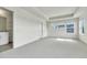 Bright bedroom with tray ceiling, carpeted floor, with an adjoining bathroom visible through the door at 7277 W Adriatic Cir, Lakewood, CO 80227