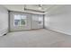Large bedroom with tray ceiling, carpeted floor, and windows that let in ample natural light at 7277 W Adriatic Cir, Lakewood, CO 80227